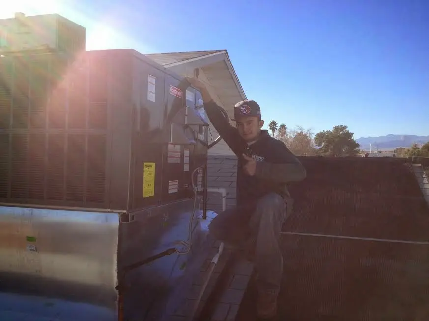 HVAC technician performing Heat Pump Repair on a rooftop unit in Abingdon